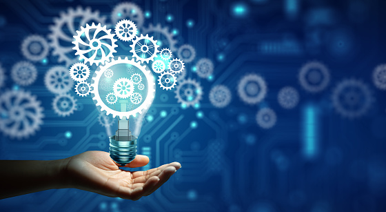 Hand holding Creative light bulb with cog inside and technology background. Innovation business idea knowledge, Planing strategy, and Analysis solution development Concept.